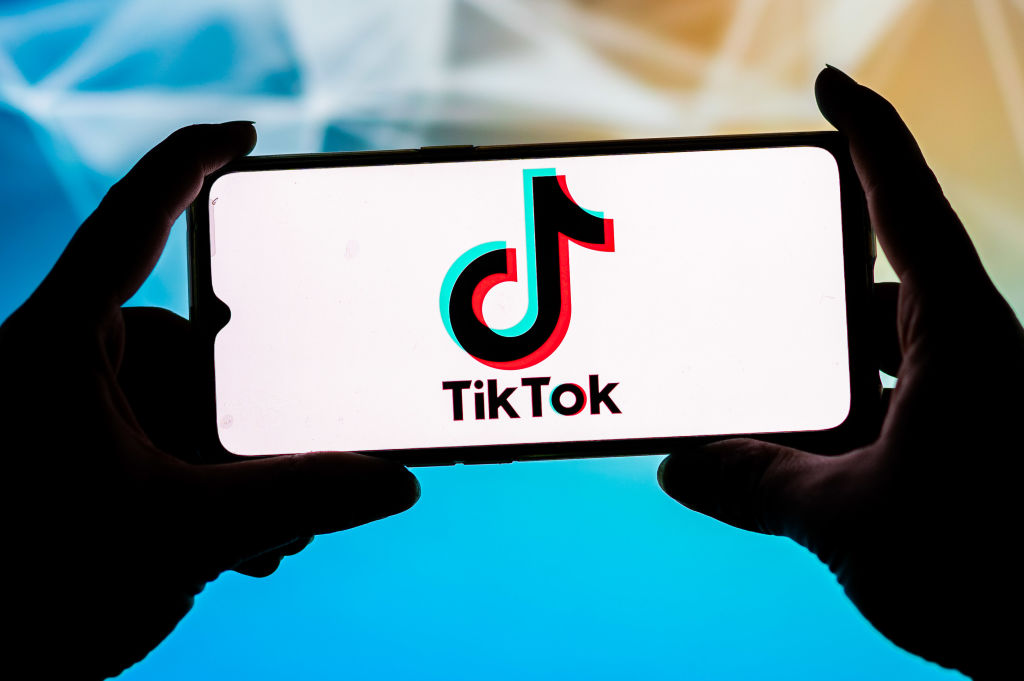 In this photo illustration a TikTok logo seen displayed on a...