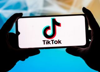 In this photo illustration a TikTok logo seen displayed on a...