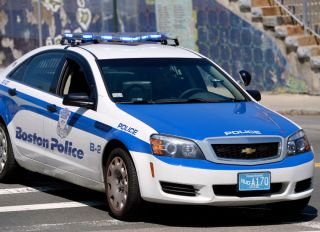 (Boston, MA, 05/21/14) A Boston Police cruiser blocks off Dudley Street as police investigate the scene of a shooting in Boston on Wednesday, May 21, 2014. car squad Staff photo by Christopher Evans.