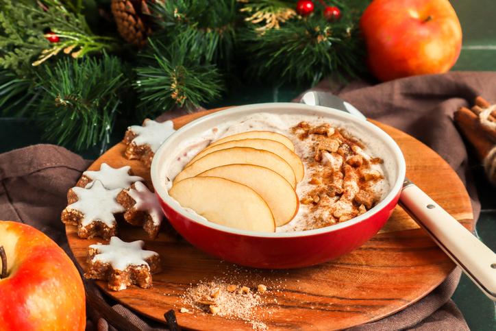 Porridge bowl with baked apple dessert with cinnamon and nuts