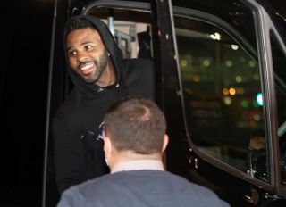 Jason Derulo is seen in a car smiling at the people after...