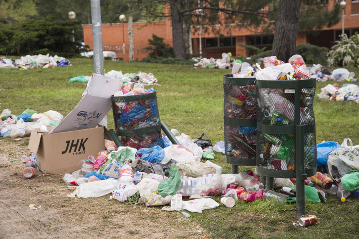 Overflowing bins in a park of Ciudad Universitaria, Madrid