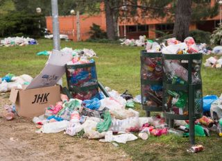 Overflowing bins in a park of Ciudad Universitaria, Madrid