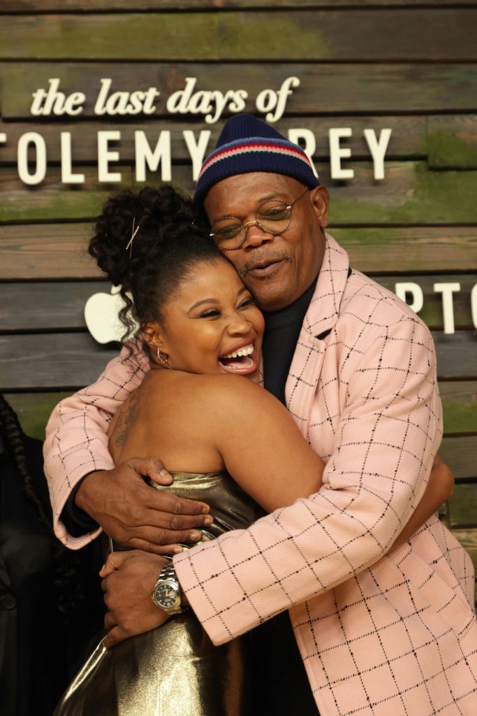 Dominique Fishback hugs Samuel L. Jackson at the series premiere of Apple Original limited series “The Last Days of Ptolemy Grey” at The Bruin in Los Angeles, CA, on March 7, 2022. “The Last Days of Ptolemy Grey” premieres on Friday, March 11, 2022 on Appl