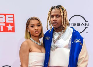 Lil Durk and India Royale pose on the red carpet at the BET Awards 2021 .