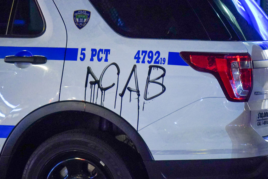 A NYPD squad car vandalized during the demonstration.