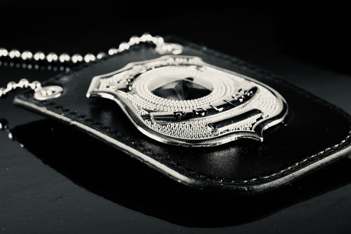 police detective badge against a black background