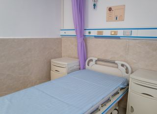 Empty hospital bed in hospital room