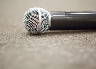 Selective focus of Microphone on stage floor background