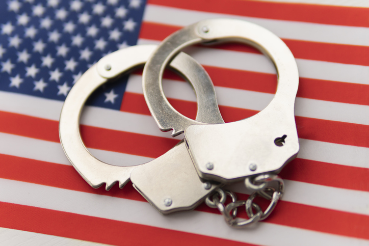 USA flag and police handcuffs. The concept of crime and offenses in the country. concept of crime in the state or government of the country.