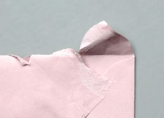 Torn envelope on a grey background