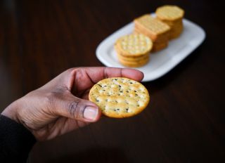 Woman Snacks on Crackers