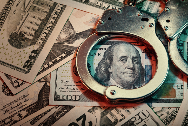 Handcuffs and US banknotes