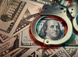 Handcuffs and US banknotes