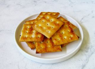 Crackers on a white ceramic plate on a white background