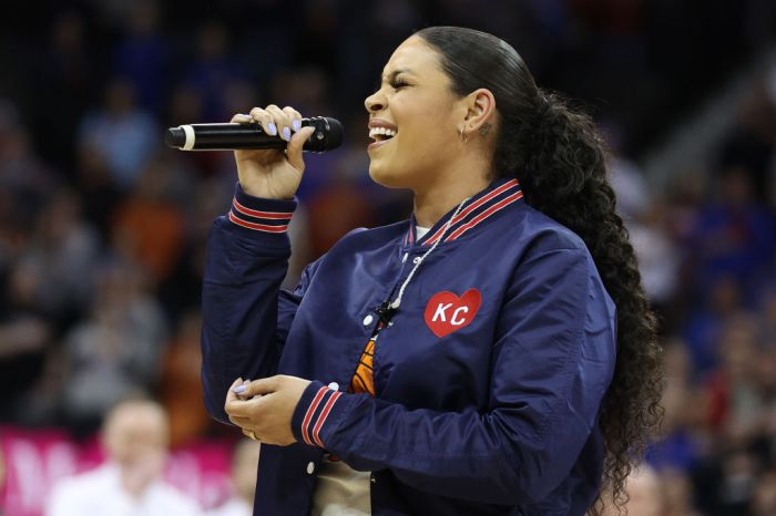 Jordin Sparks singing at the the National Anthem at the Big 12 Tournament Championship Game between Texas v Kansas