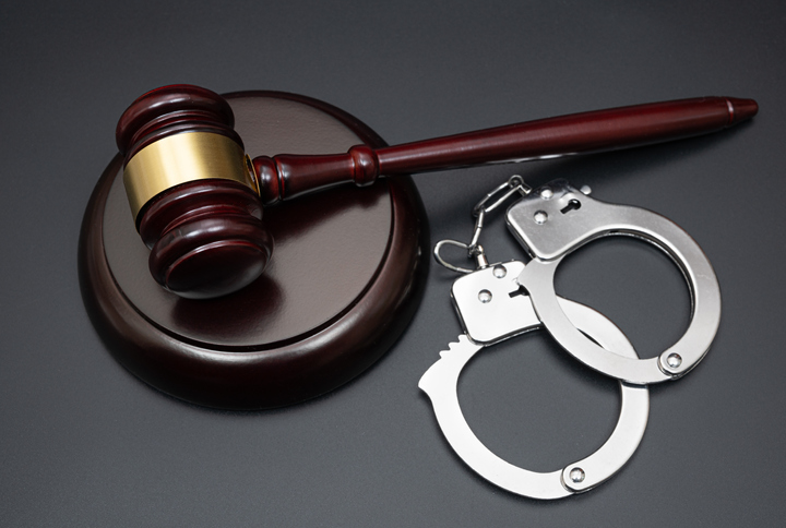 Judge gavel handcuffs on black background