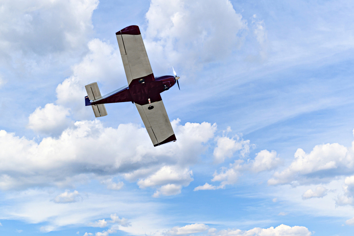 Youtuber - Light aircraft flying over blue sky