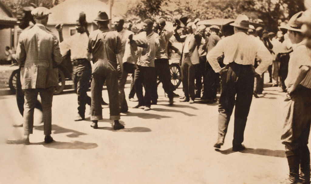 Detained African American men with Hands raised in Surrender in Greenwood Neighborhood during Tulsa Race Massacre, Tulsa, Oklahoma, USA, Unidentified Photographer, June 1921