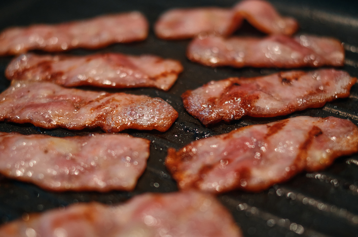 Close up of grilled bacon on the frying pan