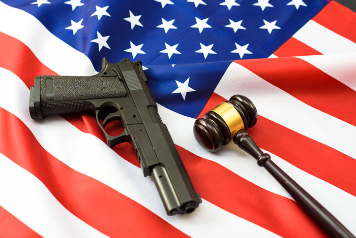 Judges rule on the use of civilian weapons, patriotic flag with pistol.