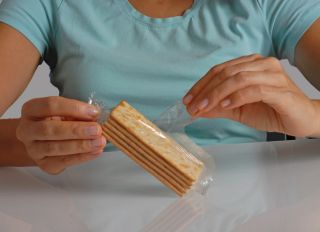 Hand opening cracker soda package.