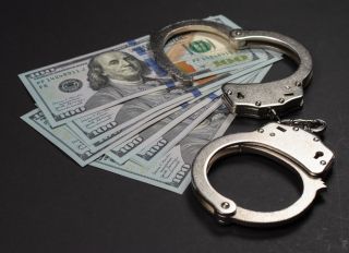 American dollars and handcuffs, Concept of ideas of corruption, dirty money or financial crimes