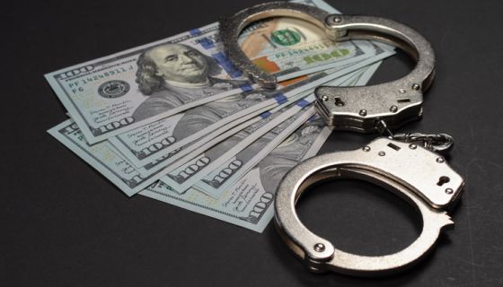 American dollars and handcuffs, Concept of ideas of corruption, dirty money or financial crimes
