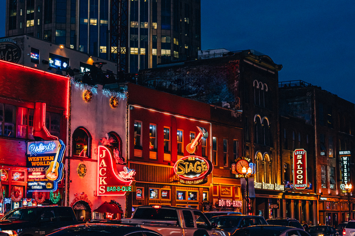 Christmas Decorations, Vibrant neon signs and traffic on Broadway in Downtown Nashville, Tennessee at Dusk
