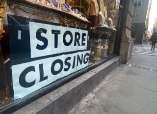 Store Closing sign in window of Antiques shop on Upper East Side, Manhattan