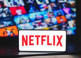 In this photo illustration, the Netflix logo is displayed on...