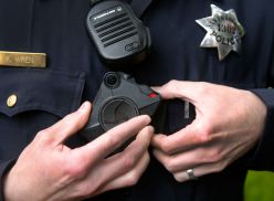 Police officer Kyle Wren attaches a body worn camera to his uniform outside of the Ingleside police station in San Francisco, Calif. on Sept. 1, 2016. Wren was one of the first officers from the Bayview station to field test the cameras before they were i