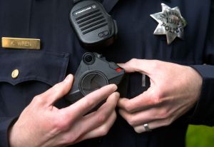 Police officer Kyle Wren attaches a body worn camera to his uniform outside of the Ingleside police station in San Francisco, Calif. on Sept. 1, 2016. Wren was one of the first officers from the Bayview station to field test the cameras before they were i