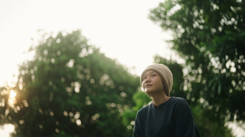 Teenager relaxing at park.