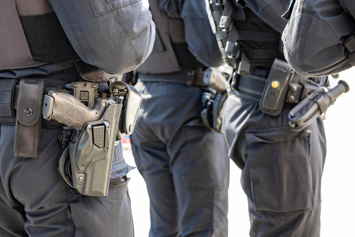 Three German police officers and their equipment belts with gun