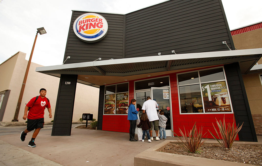 Pedestrians walk past the newly remodeled Burger King Restaurant located at 1200 East Colorado Stre