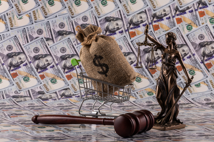 Themis figure and a judge's gavel against the background of $100 bills