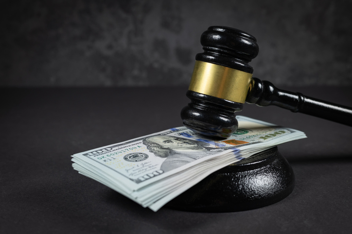 Law and justice concept. Judge hammer with the dollar placed - concept of judgment and justice. About fraud tax fines