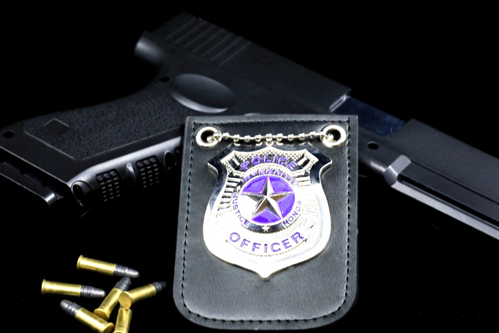 Local cops concept with badge, gun, and bullets