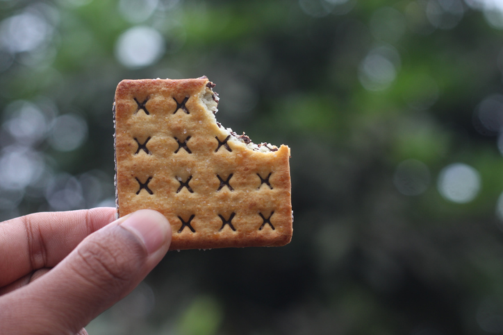 Man holding bitten cookie
