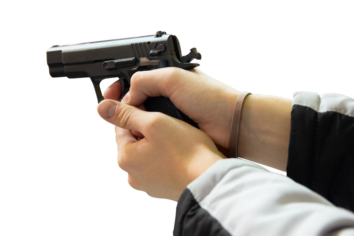 A gun in the hands of a man isolated on a white background
