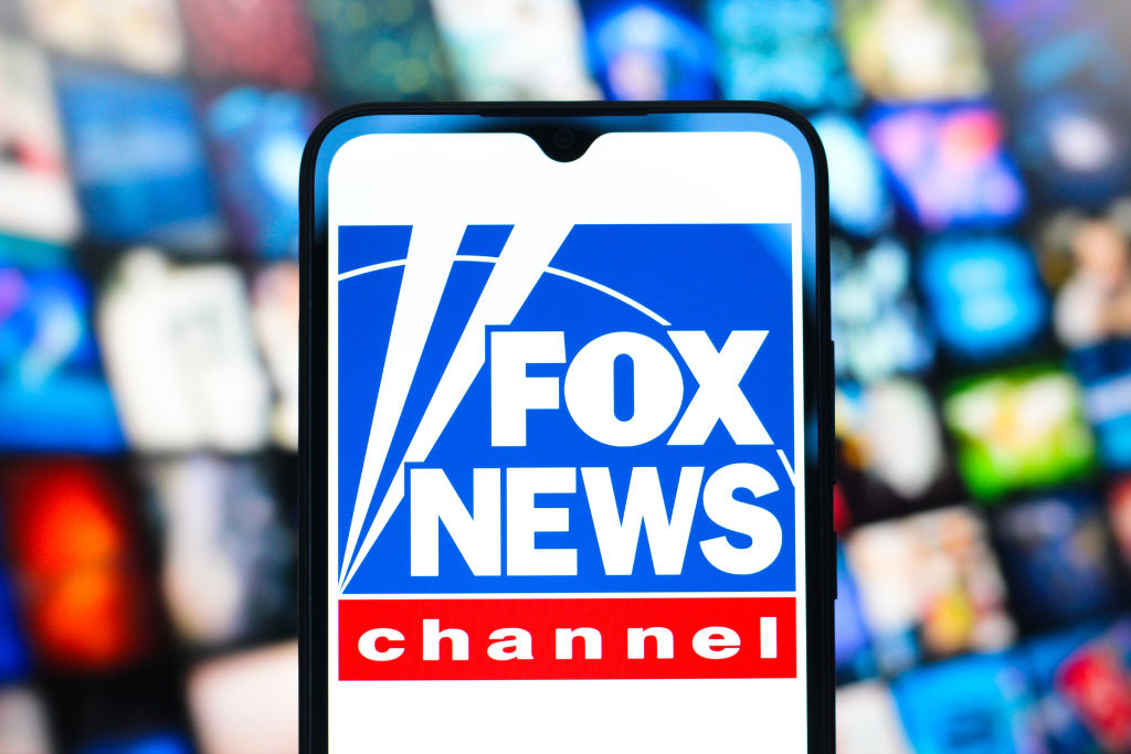 In this photo illustration, the Fox News Channel logo is...
