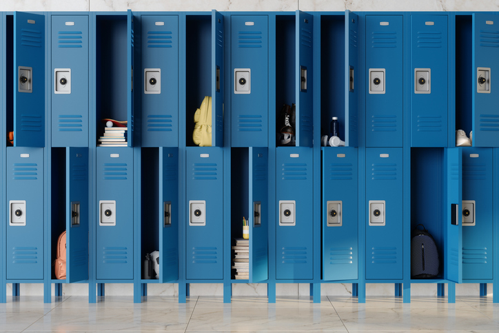 Open Blue School Lockers With Backpacks, Books And Personal Items Inside. Educational Environment And Student Life Concept