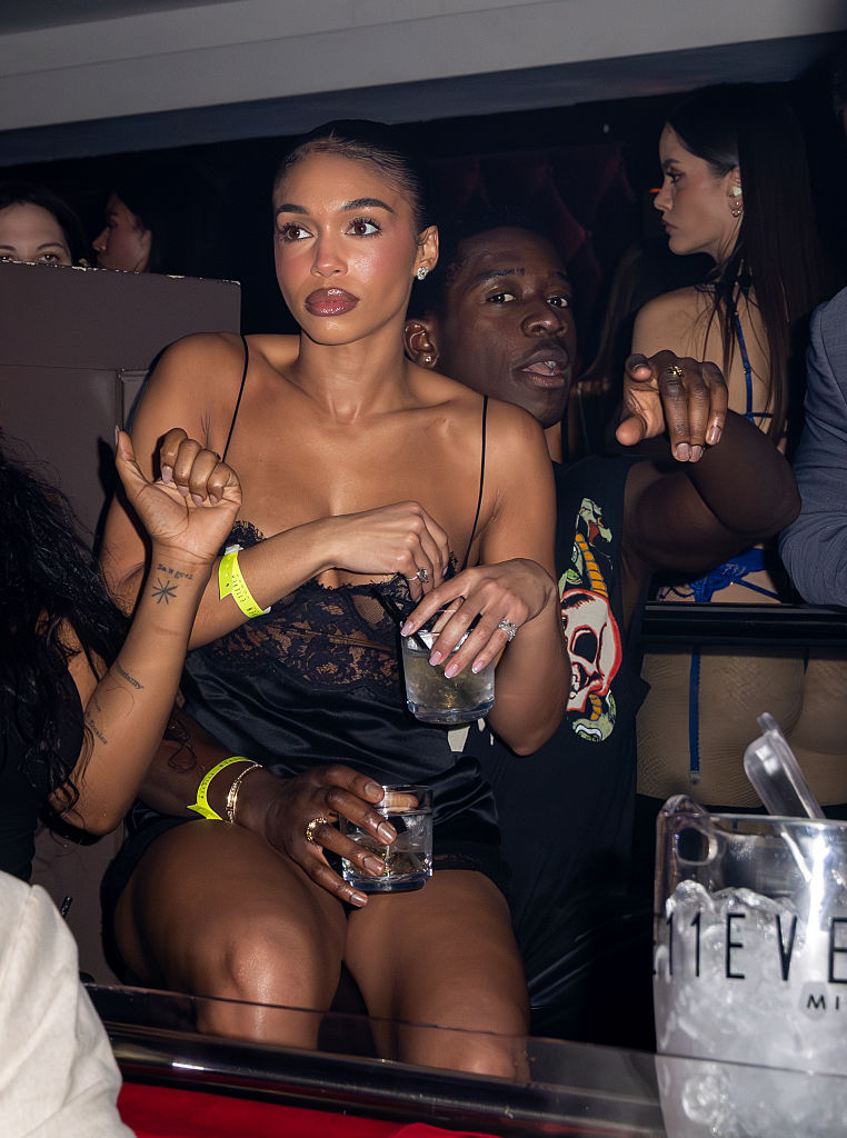 Lori sitting on Damson Idris's lap at Art Basel 2025 in Miami, Florida