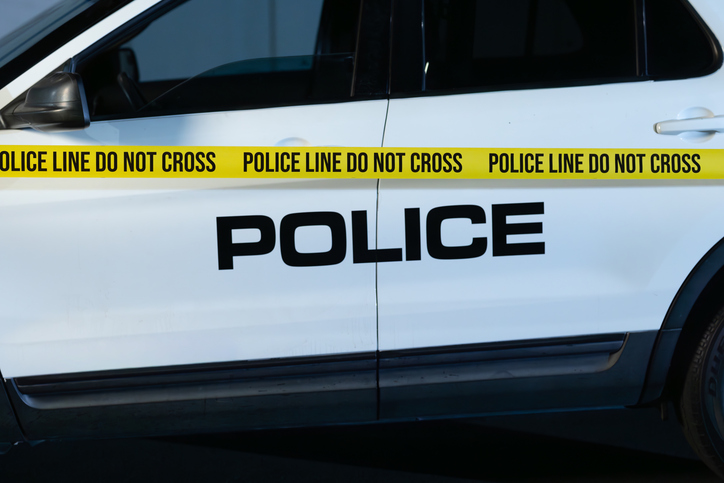 Police Tape Unrolled Across Police SUV