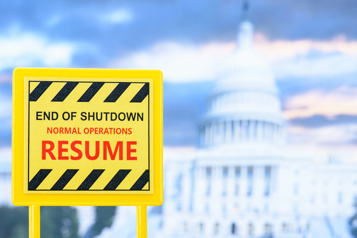 A sign announcing the reopening of the U.S. federal government after a shutdown, with the Capitol building in the background. Concept for public administration, political events, economic updates, etc