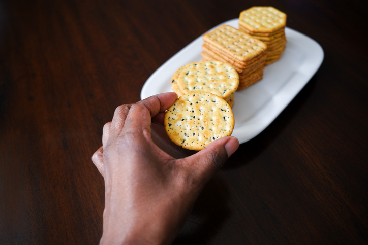 Woman Snacks on Crackers