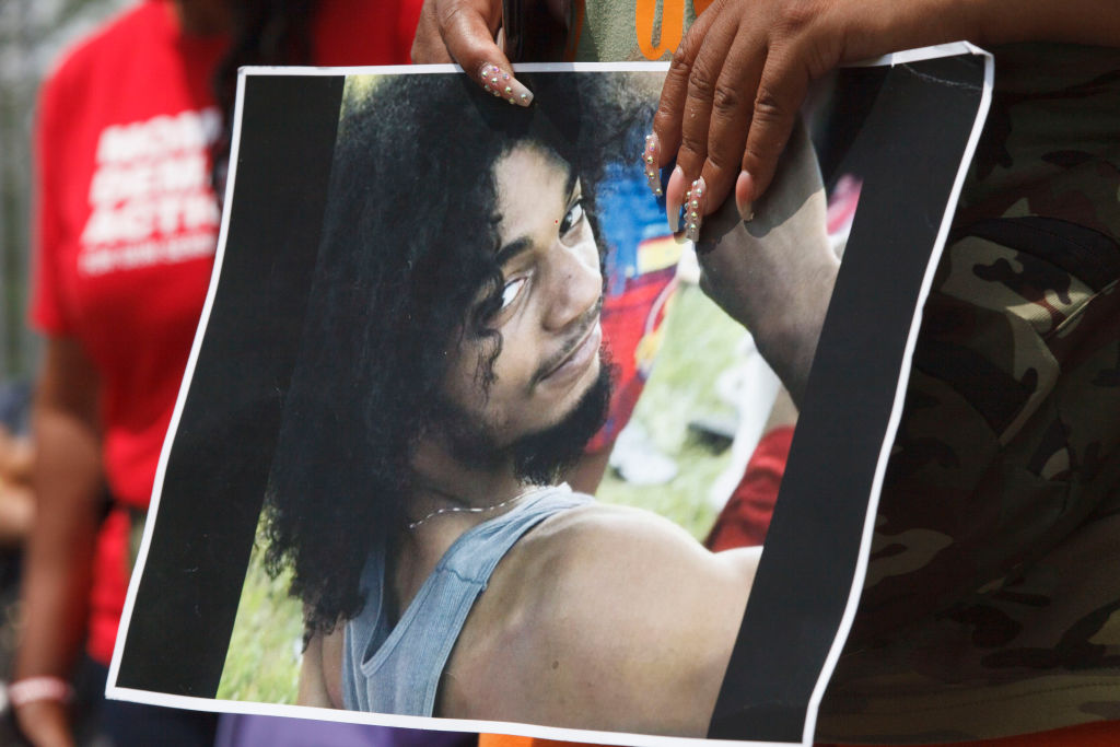 Black Lives Matter activist holds a picture of Casey Goodson