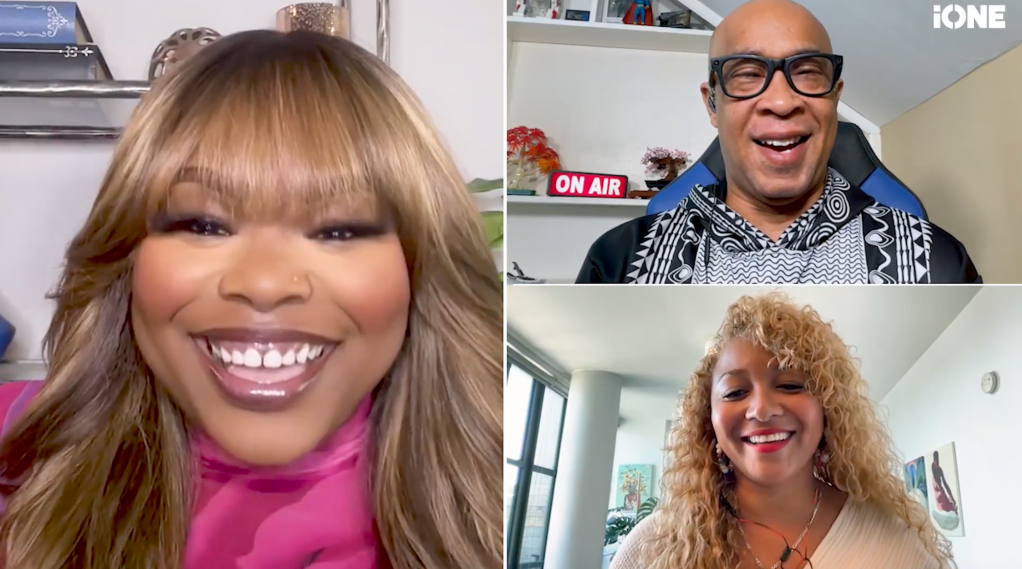 Three smiling people in a video call: a woman with blonde hair, a man with glasses, and a woman with curly hair.