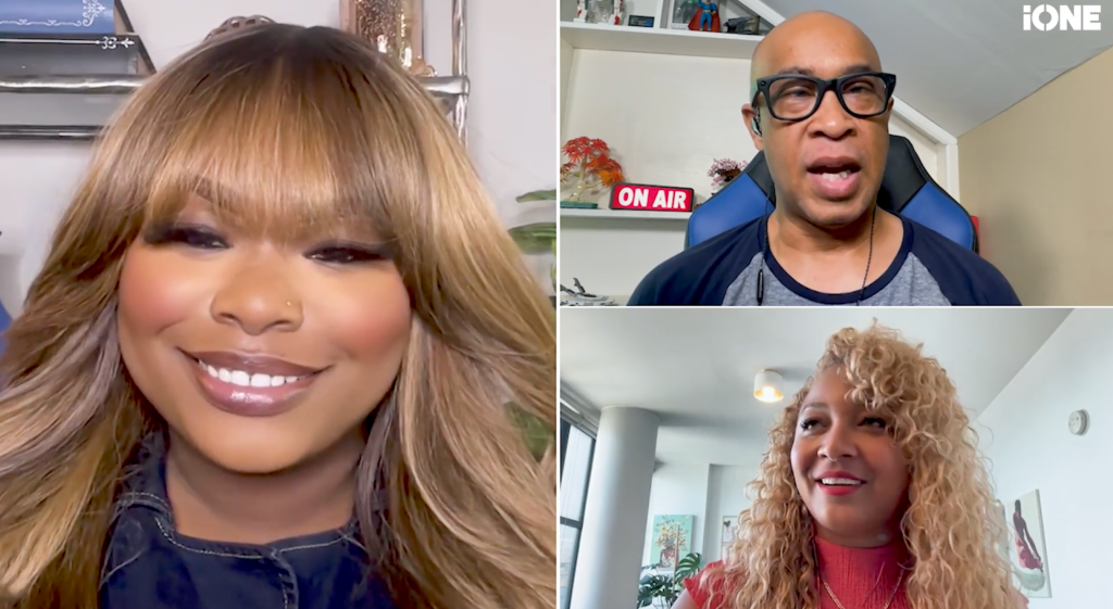 Three people in a video call: a woman with long blonde hair smiling, a bald man wearing glasses, and a woman with curly blonde hair.